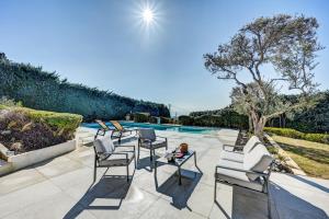 a patio with chairs and a table next to a swimming pool at The View Aix-en-Provence in Aix-en-Provence