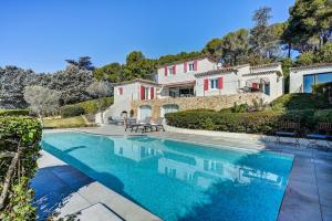 a swimming pool in front of a house at The View Aix-en-Provence in Aix-en-Provence