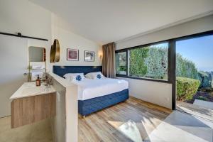 a bedroom with a bed and a large window at The View Aix-en-Provence in Aix-en-Provence +29 photos