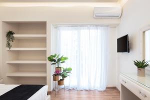 A television and/or entertainment centre at Acropolis Prestige Residence