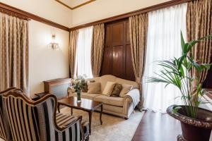 a living room with a couch and a table at Hotel Bellevue - Liburnia in Opatija