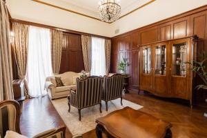 a living room with a table and chairs and a couch at Hotel Bellevue - Liburnia in Opatija