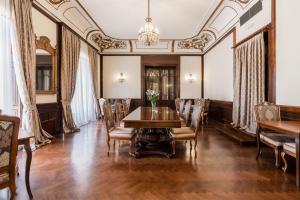a dining room with a table and chairs at Hotel Bellevue - Liburnia in Opatija