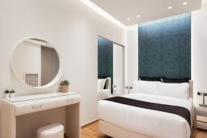 A bed or beds in a room at Acropolis Prestige Residence