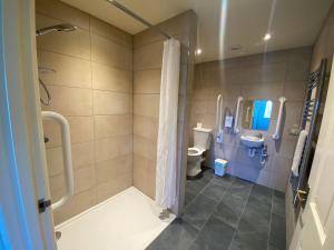 a bathroom with a shower and a toilet at Croyde Bay Hotel or Self Catering in Croyde