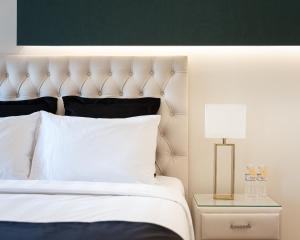 A bed or beds in a room at Acropolis Prestige Residence