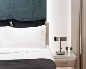 A bed or beds in a room at Acropolis Prestige Residence