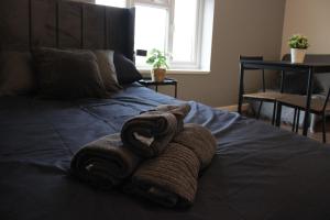 un par de toallas sentadas encima de una cama en Superb Studio Flats in City Centre en Southampton