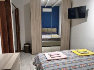 a small room with a bed and a mirror at Mizzica bed and breakfast in Catania