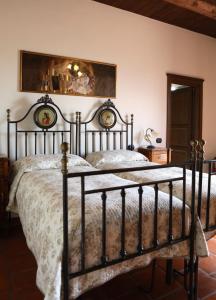 a bedroom with a bed with a metal frame at Domus Letizia in Campora