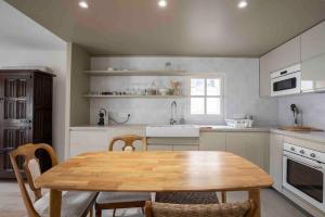 una cucina con un tavolo e delle sedie in legno di Bel Appart avec CLIM en DUPLEX - TERRASSE - Wifi ad Avignone