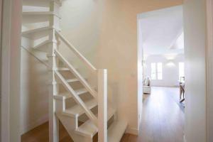 scala a chiocciola bianca in una stanza bianca di Bel Appart avec CLIM en DUPLEX - TERRASSE - Wifi ad Avignone