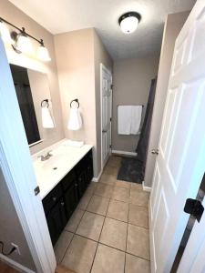 a bathroom with a sink and a mirror at Peaceful Townhouse Near Lake in Guntersville