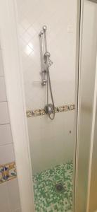 a shower with a glass door in a bathroom at Hotel Bristol in Vietri