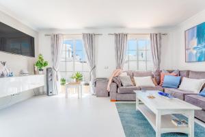 a living room with a couch and a table at Casa Laura in Puerto del Carmen