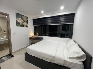 a bedroom with a large white bed and a window at Noric homestay in Hue