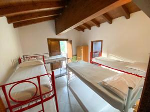 a room with three bunk beds in a room at Acatú in Monzuno