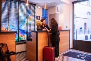 two women are standing at a counter in a store at Boutique Hotel Villa du Taur in Toulouse