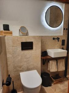 La salle de bains est pourvue de toilettes, d'un lavabo et d'un miroir. dans l'établissement BACHMEIERs Stüber'l, à Altdorf bei Nürnberg