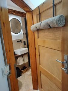 a door to a bathroom with a sink and a mirror at BACHMEIERs Stüber'l in Altdorf bei Nuernberg