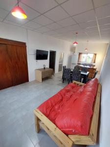 a living room with a red couch in a room at Cabañas Apart del Sauce II in Paraná