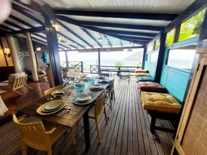 a dining room with a table and chairs on a boat at VILLA COCO ROSE in Les Anses-dʼArlets