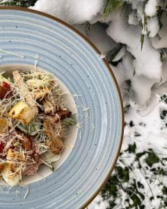 a bowl of food on a table with snow at Ліжниця in Radekhov