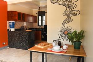 a kitchen with a wooden table in a room at Charming 2-Bed House in Kampala in Kampala