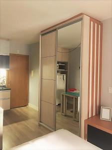 a kitchen with a sliding glass door leading to a refrigerator at Studio Moderno e Aconchegante in Curitiba