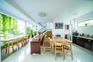 a dining room with wooden tables and chairs at My Anh Boutique Villa Hoi An in Hoi An