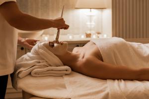 a woman getting a massage in a towel at Hotel Bellevue - Liburnia in Opatija