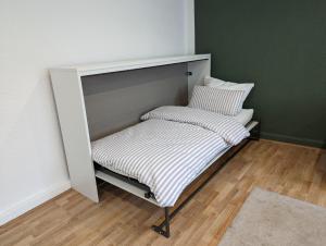 a bed with two pillows on it in a room at Ihre Ferienwohnung in 67454 Haßloch - Pfalz in Haßloch