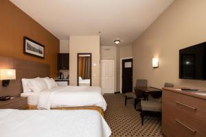 a hotel room with two beds and a desk at Holiday Inn Express & Suites Tremblant, an IHG Hotel in Mont-Tremblant