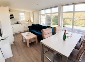 a living room with a table and a couch at Strandbungalow Jette in Glowe
