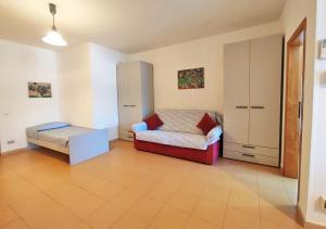 a room with a bed and a cabinet in it at Orizzonti in Marina di Campo