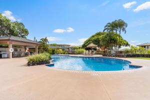 a swimming pool in the middle of a yard at Sun, Beach, Golf Romantic Getaway! A Safe Place in Kahana