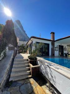 a house with a swimming pool with a pyramid in the background at Villa Antalya Esiyok in Antalya