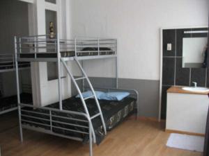a room with two bunk beds and a desk at Logies Lucullus in Blankenberge