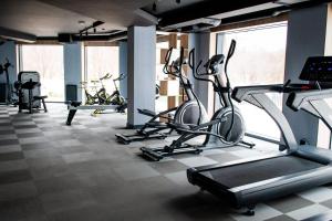 a gym with several cardio bikes in a room at Porto in Gdańsk