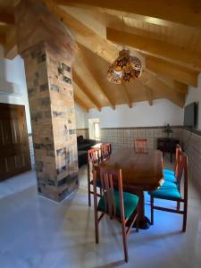 a dining room with a wooden table and chairs at La carchata ático in Siete Aguas