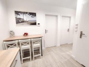 a kitchen with a table and chairs in a room at Porto in Gdańsk