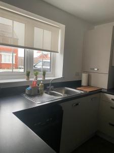 a kitchen with a sink and a window at Henry Blythe Gardens in Thame
