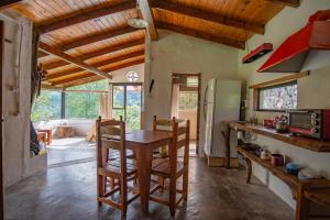 a kitchen with a wooden table and a refrigerator at Finca Villa Maria in Yala