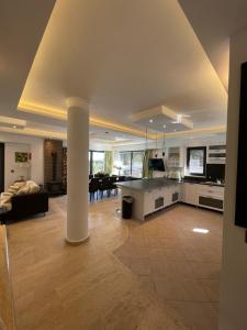 a large kitchen and living room with a column at Villa Antalya Esiyok in Antalya