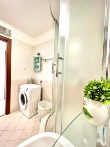 a bathroom with a shower and a washing machine at Apartment Angel in Split