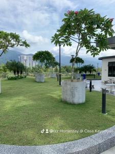 a park with a tree in the grass at Barakah Homestay @ Meru Casa Kayangan in Ipoh