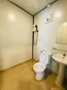 a bathroom with a toilet and a sink at KORA-GREAT Airport Phuket in Nai Yang Beach