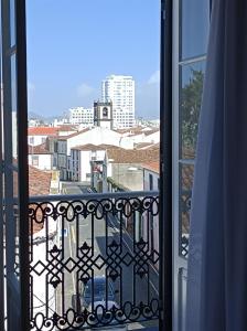 a view of a city from a balcony at Santo Cristo Apartments in Ponta Delgada