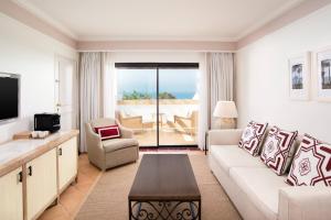 a living room with a couch and a table at Pine Cliffs Hotel, a Luxury Collection Resort, Algarve in Albufeira