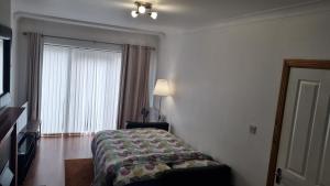 a hotel room with a bed and a window at Modern Apartment good distance from Dublin City and Airport 4people in Dublin